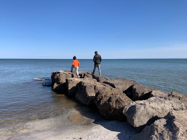 D and KrA climbing rocks on a pier jutting into Lake Ontario