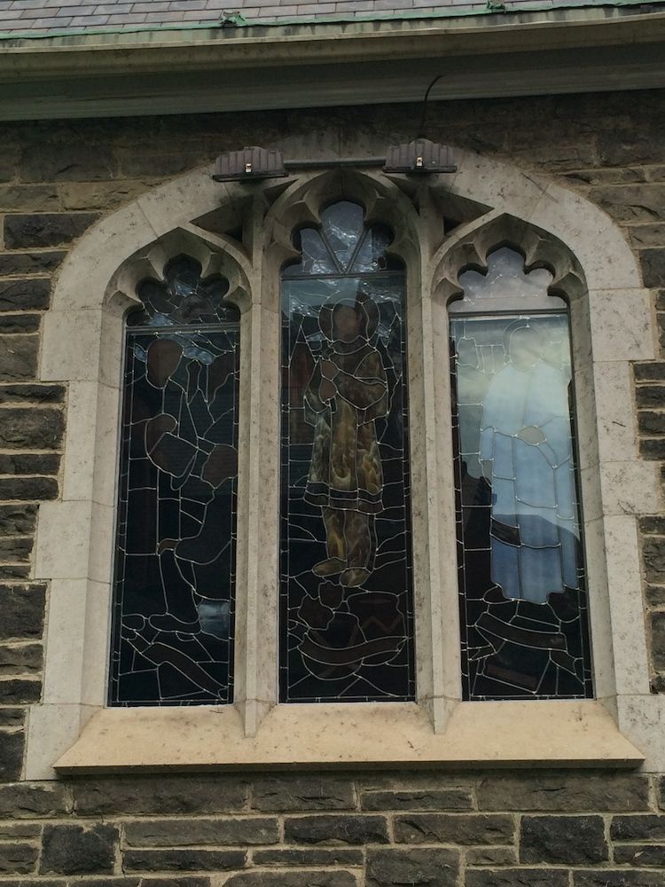 window pane of a church with three robed figures painted on it