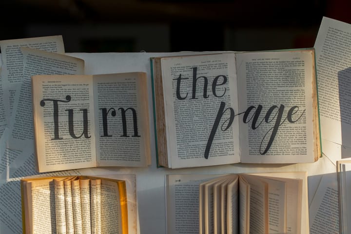 open books and pages with a caption 'Turn the page' 