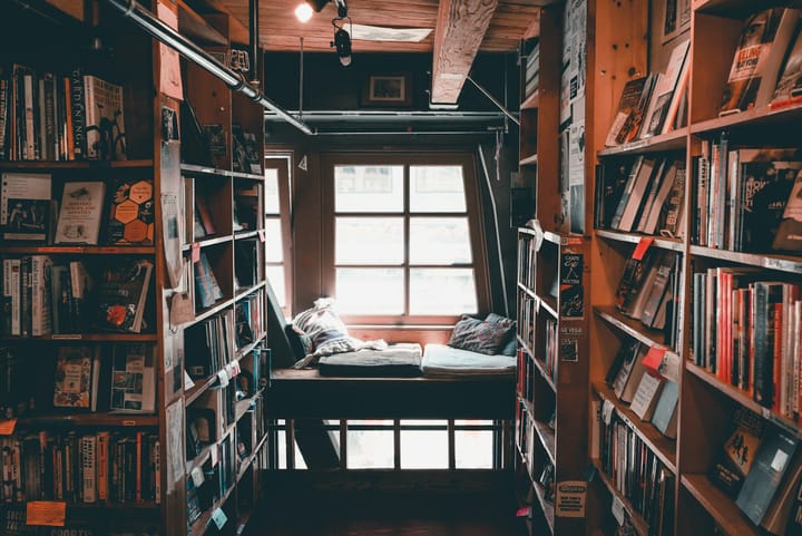 a reading nook surrounded by shelves of books